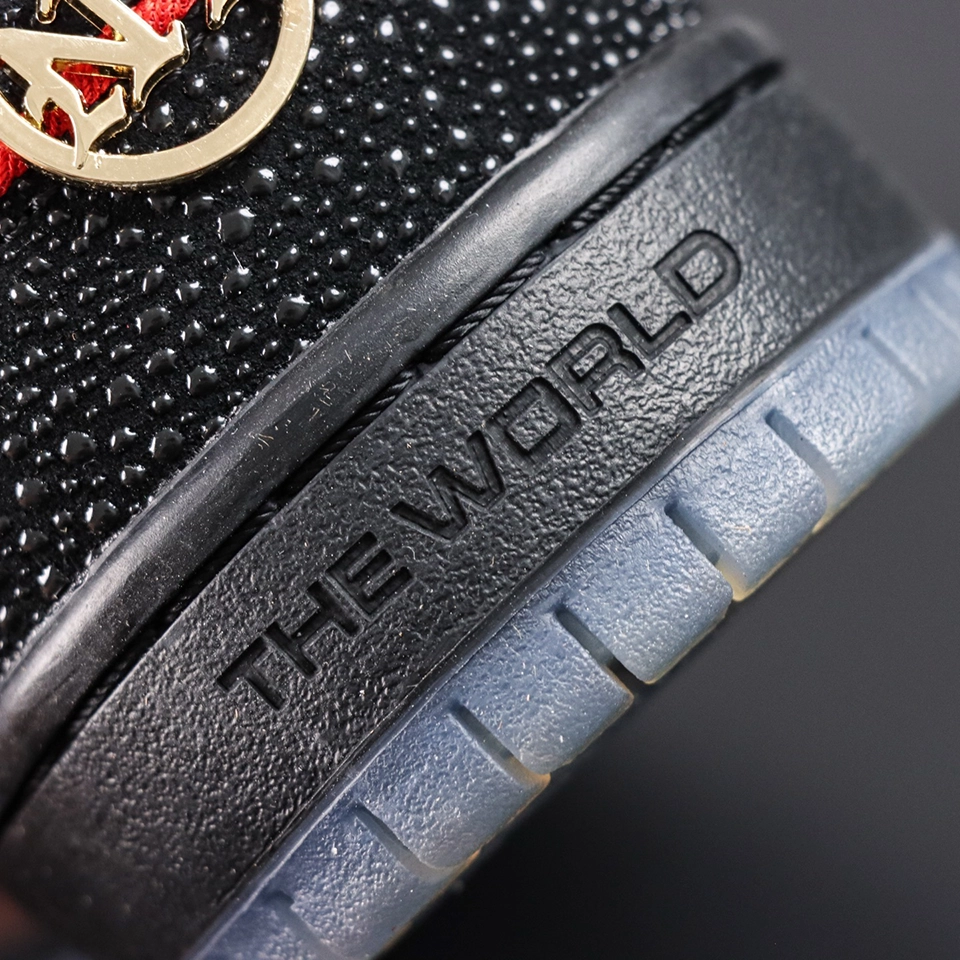 Close-up of Bronx Girls Skate x Nike Dunk Low SB ‘Mel & Kava’ heel with gold NYC emblem and embossed “THE WORLD” text on black midsole