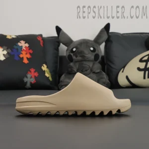 Yeezy Slides ‘Pure’ lateral view against black background emphasizing silhouette
