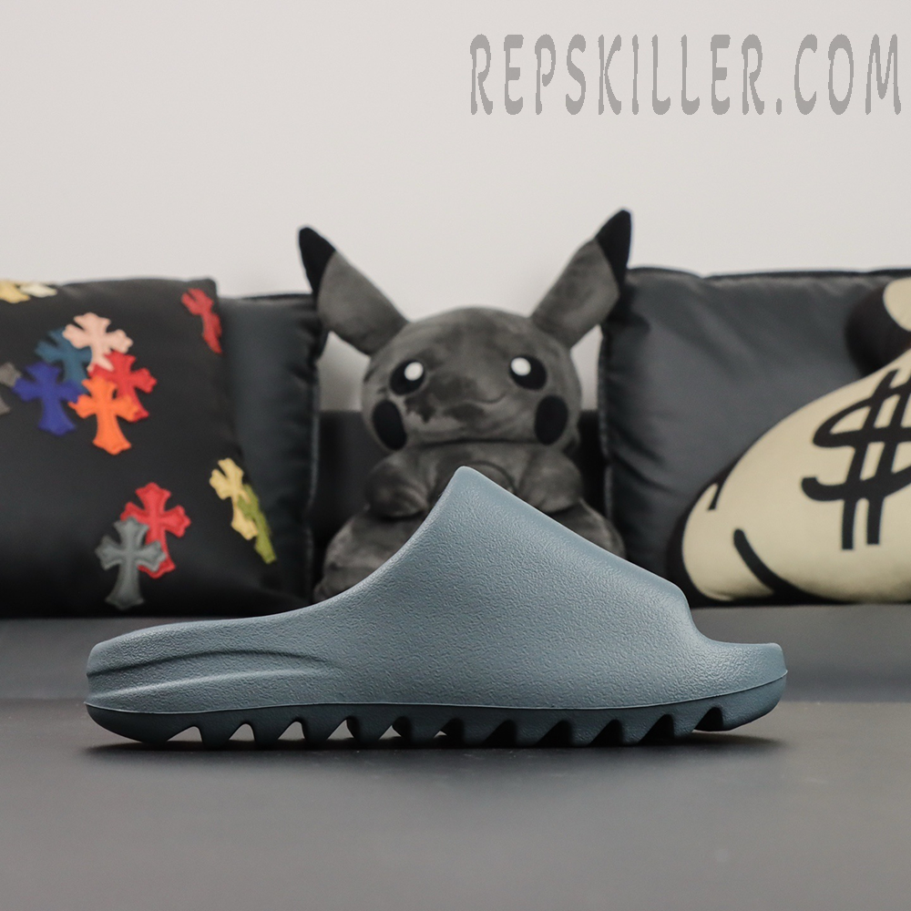 Side profile of the Yeezy Slides ‘Slate Marine’ showing minimal design and clean ridges.