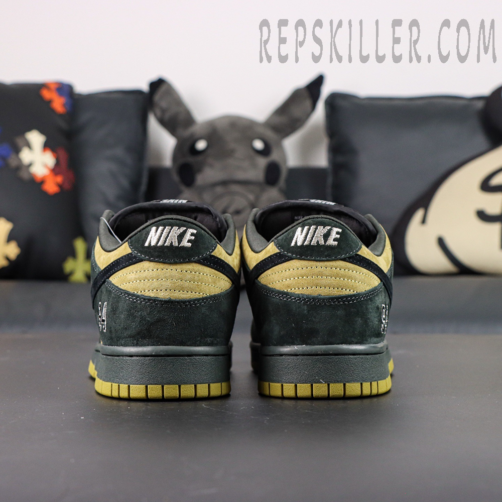 Nike Supreme x Dunk Low SB “Camper Green” back heel view emphasizing NIKE embroidery and dual suede texture.