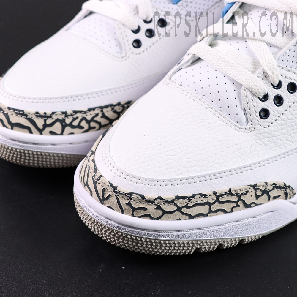 Close-up of Air Jordan 3 “UNC” toe box showing tumbled white leather and signature elephant print overlay.