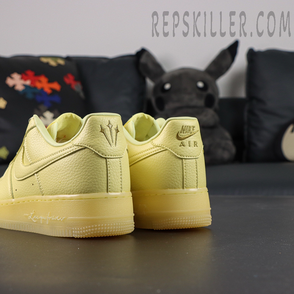 Rear angled view of NOCTA x Air Force 1 “Citron Tint” showing dual heel logos and soft leather texture.