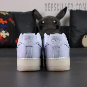 Rear view of NOCTA x Nike Air Force 1 “Palest Purple” showing embroidered Nike Air and trident heel logos.