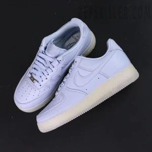 Overhead view of NOCTA x Nike Air Force 1 “Palest Purple” showing both shoes and the engraved midsole text.