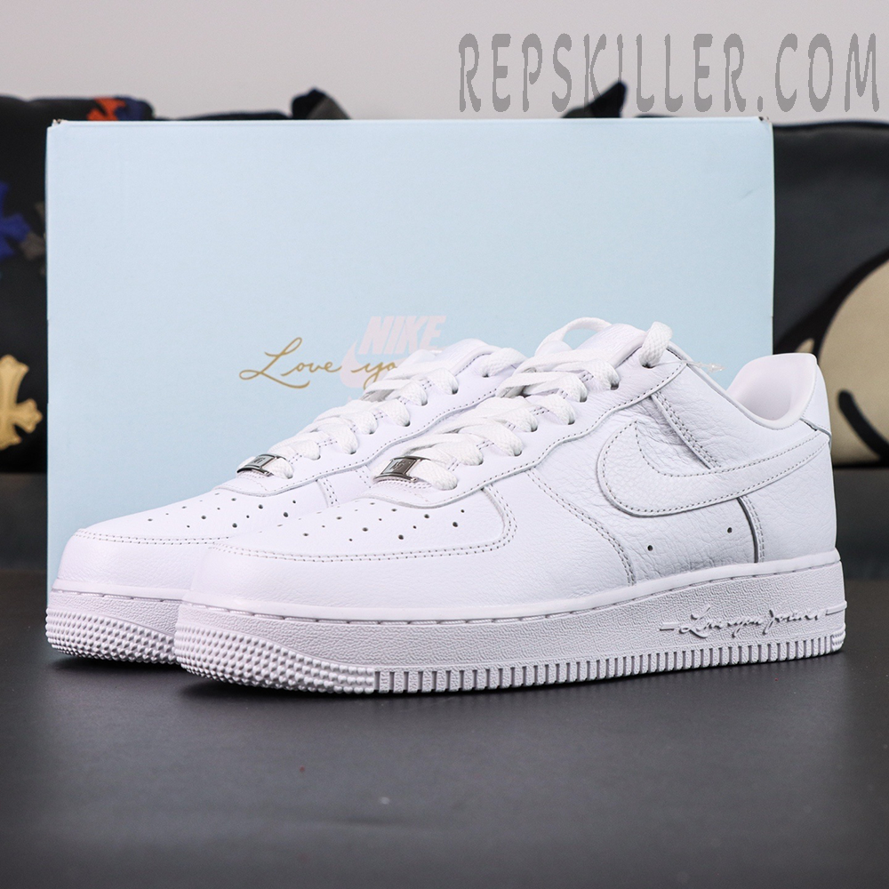 NOCTA x Nike Air Force 1 “Certified Lover Boy” with light blue box background showing elegant all-white design.