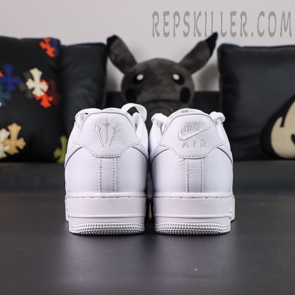 Rear view of NOCTA x Nike Air Force 1 “Certified Lover Boy” showing Nike Air and trident logos on heel tabs.