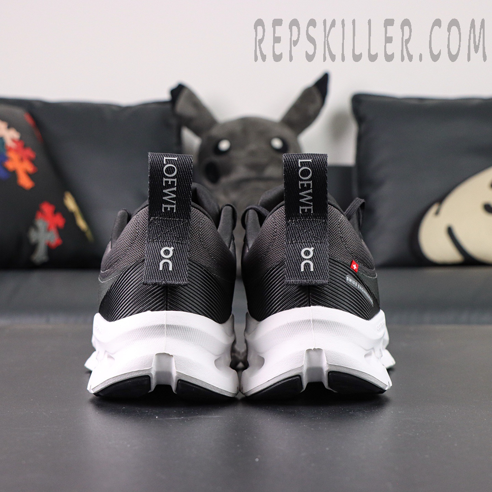 Rear view of ON L × Cloudtilt 2 “Black” showing dual pull tabs with LOEWE and On branding.
