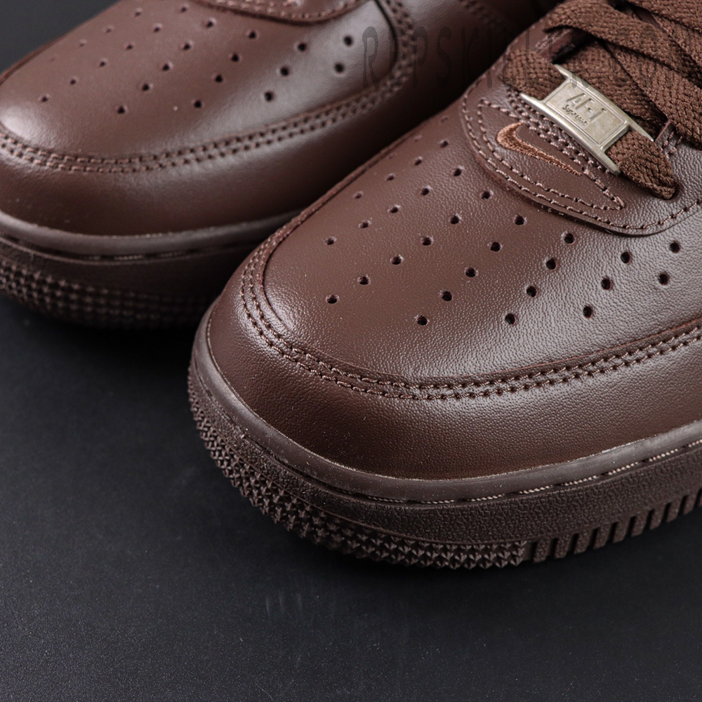 Close-up of Sup x Air Force 1 Low SP ‘Box Logo - Baroque Brown’ toe box with perforations and metal AF1 lace tag