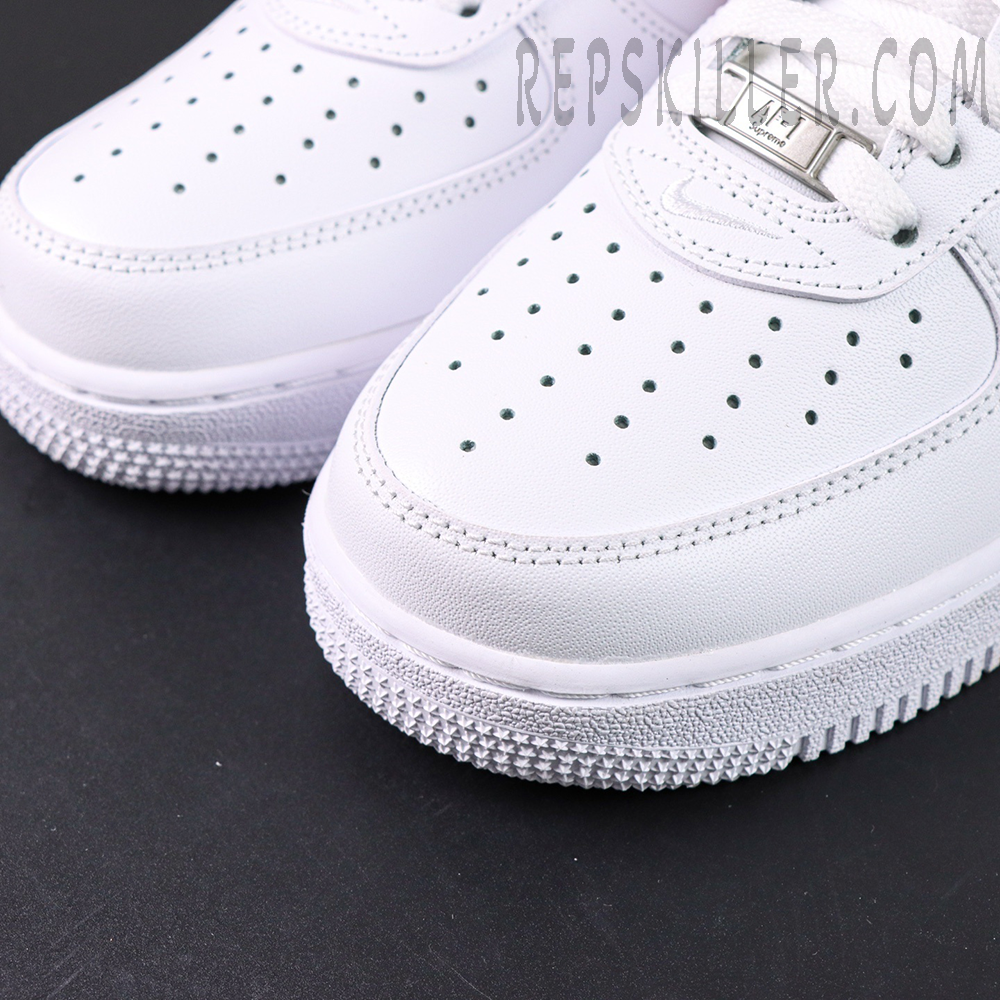 Close-up of perforated toe box on Supreme x Nike Air Force 1 Low SP ‘Box Logo - Speed Red’ with silver lace dubrae