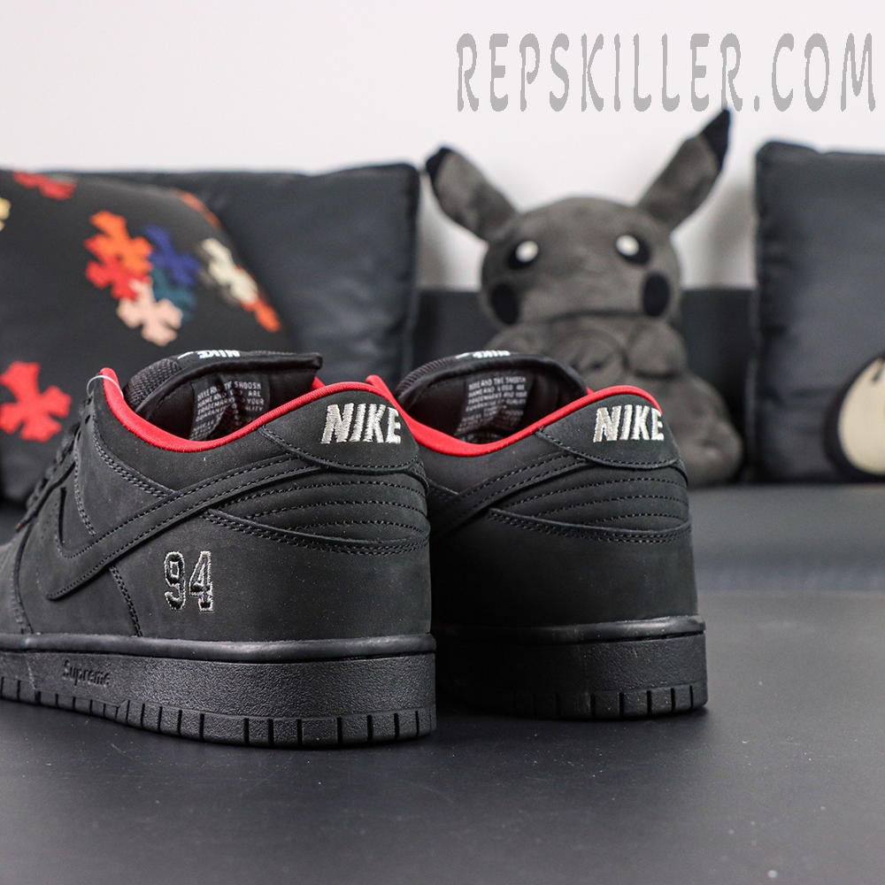 Nike Supreme x Dunk Low SB “Black” back angle showing Nike heel embroidery and matte nubuck texture.