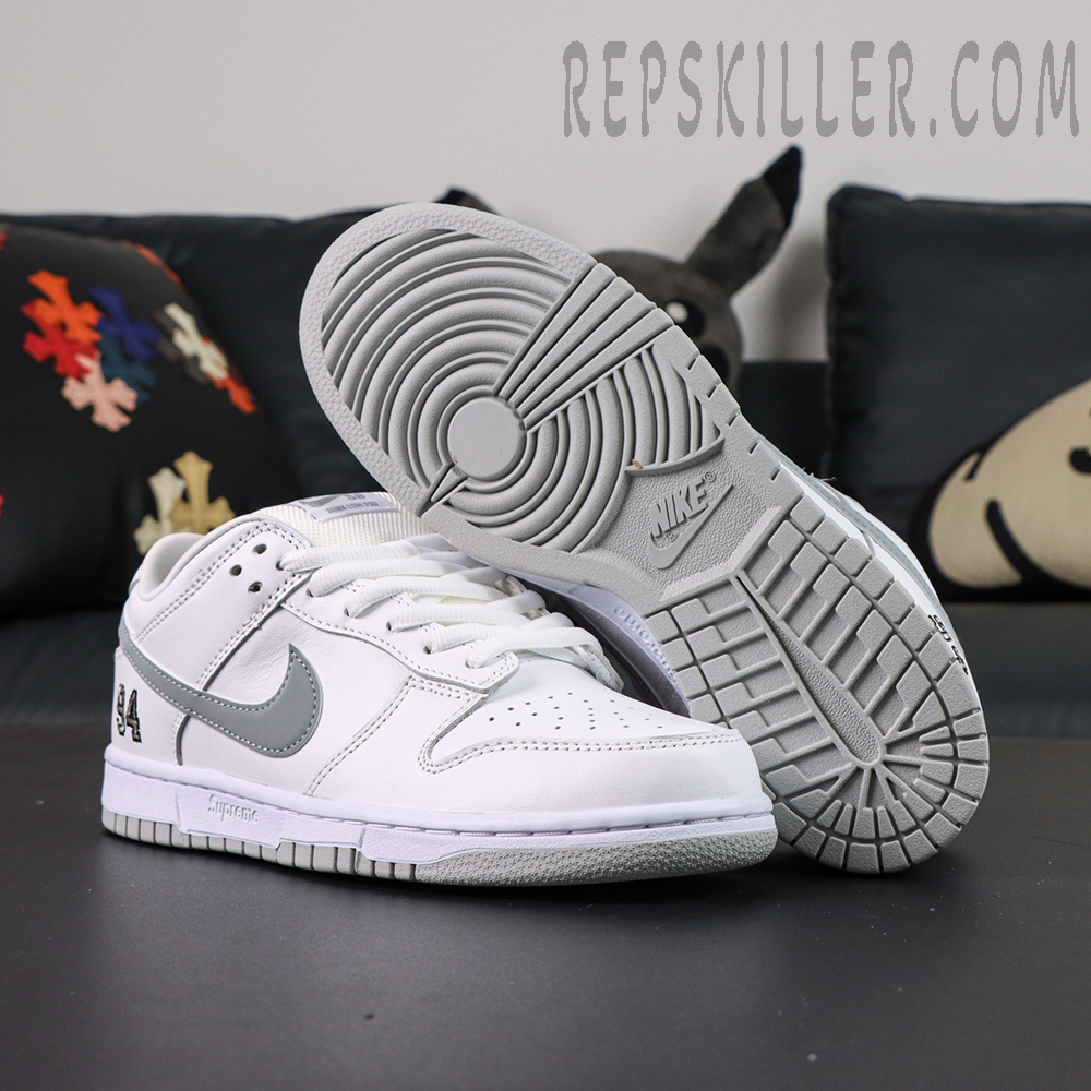Nike Supreme x Dunk Low SB “White Metallic Silver” outsole display showing classic circular traction pattern.