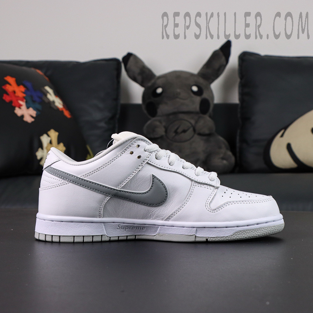 Nike Supreme x Dunk Low SB “White Metallic Silver” side profile showing metallic silver swoosh and Supreme midsole branding.