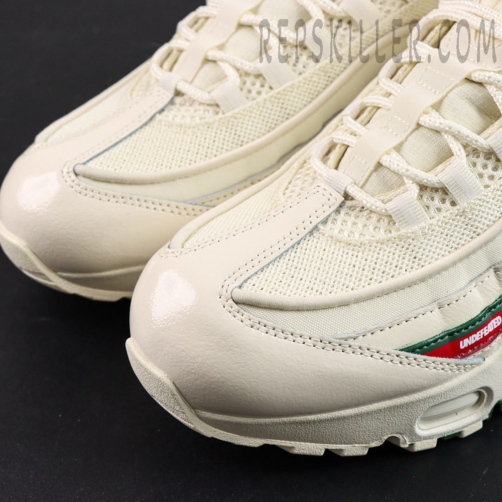 Close-up of the toe box on Undefeated x Nike Air Max 95 “Sail”, showing smooth leather and mesh texture