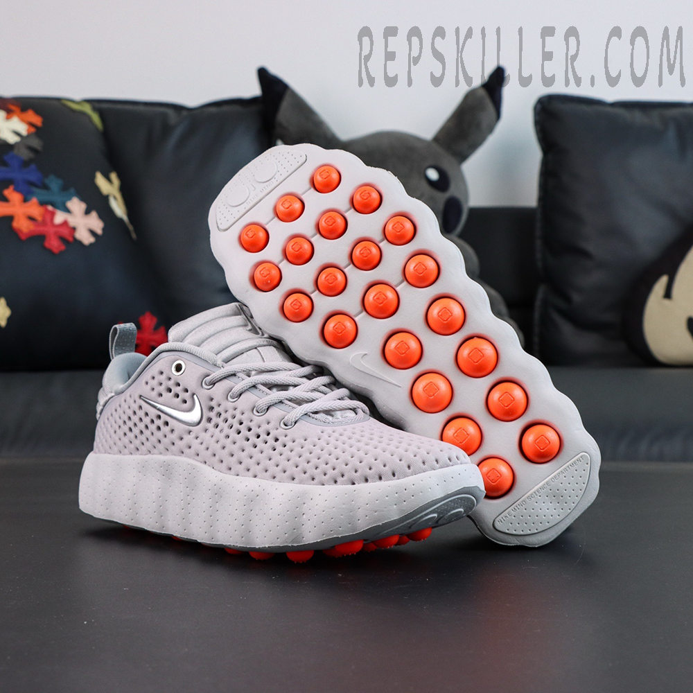 Nike Mind 002 “Light Smoke Grey” outsole with orange pods and traction system