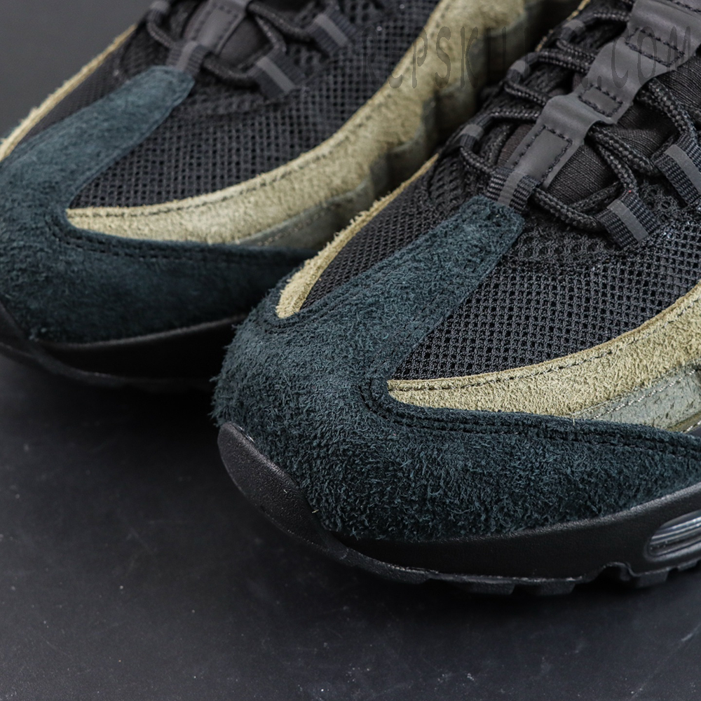 Undefeated x Nike Air Max 95 “Medium Olive” sneakers, toe box close-up with dark suede overlays and layered lines