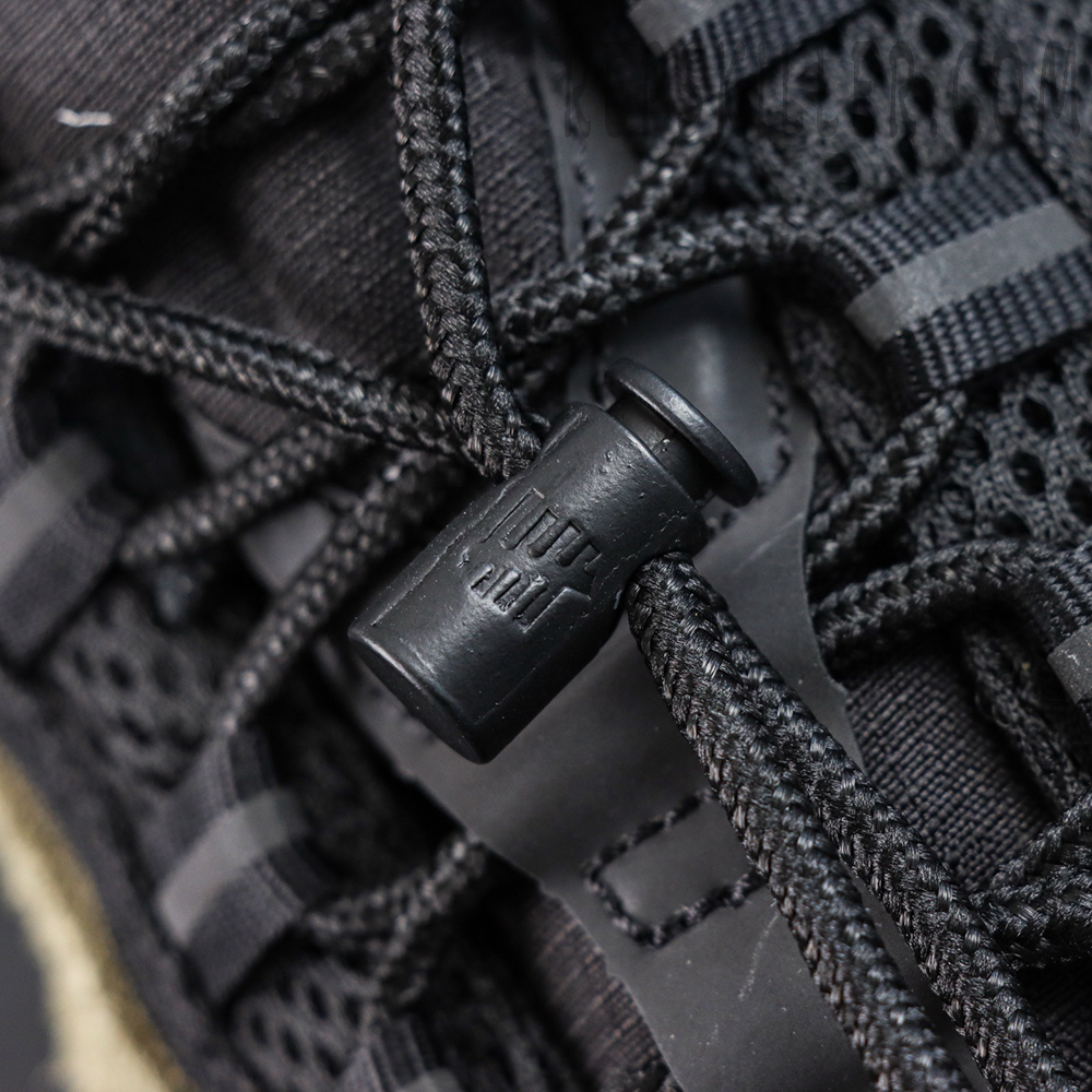 Undefeated x Nike Air Max 95 “Medium Olive” sneakers, lace system close-up with black toggle and rope laces