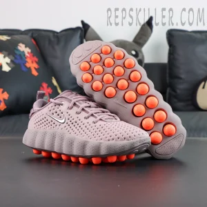 Nike Mind 002 outsole with orange cushioning pods and traction pattern