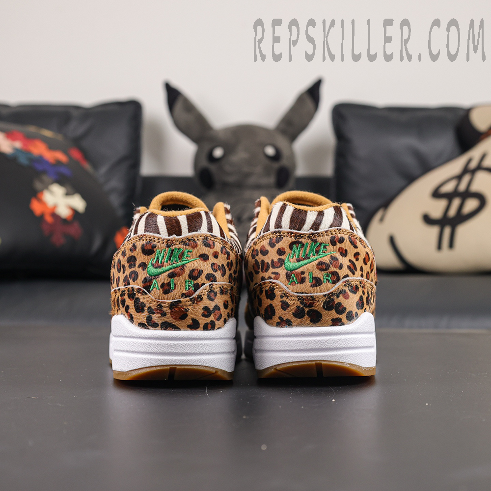 Atmos x Nike Air Max 1 DLX “Animal Pack” 2018 heel view featuring leopard print pony hair upper and green Nike Air embroidery