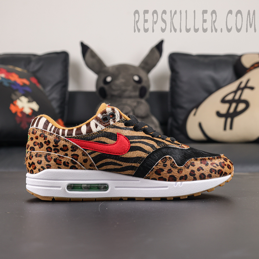 Atmos x Nike Air Max 1 DLX “Animal Pack” 2018 lateral side view with tiger stripe panels, red Swoosh and visible Air unit