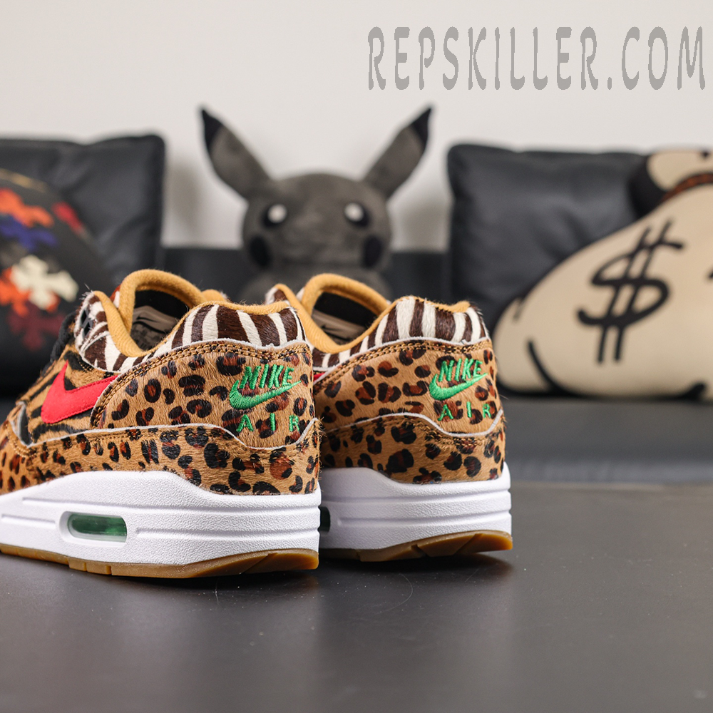 Atmos x Nike Air Max 1 DLX “Animal Pack” 2018 rear quarter view showcasing leopard print heel panels and green Nike Air embroidery