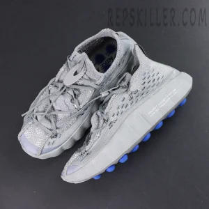 Fragment Design x Nike Mind 002 Flyknit “Particle Grey” top-down view emphasizing rugged upper texture and blue outsole pods