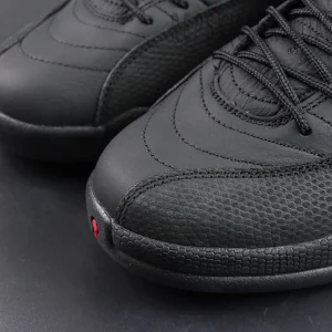 Air Jordan 12 Retro “Bloodline” toe box detail with black textured leather and red accent highlights