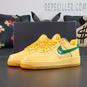 Nike Air Force 1 Low “Patent Leather Topaz Gold” full sneaker display featuring glossy yellow upper, green Swoosh, and orange-yellow laces