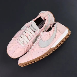 Jacquemus x Nike Moon Shoe SP “Aluminum Pink” top-down view showcasing the pale pink nylon upper and vintage low-top runner construction