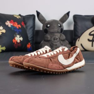 Jacquemus x Nike Moon Shoe SP “Fauna Brown” pair display featuring a sleek low-top profile and lightweight retro runner aesthetics
