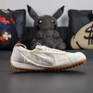 Jacquemus x Nike Moon Shoe SP “Soft Pearl” side profile featuring a soft cream ruched nylon upper with a light grey Swoosh logo