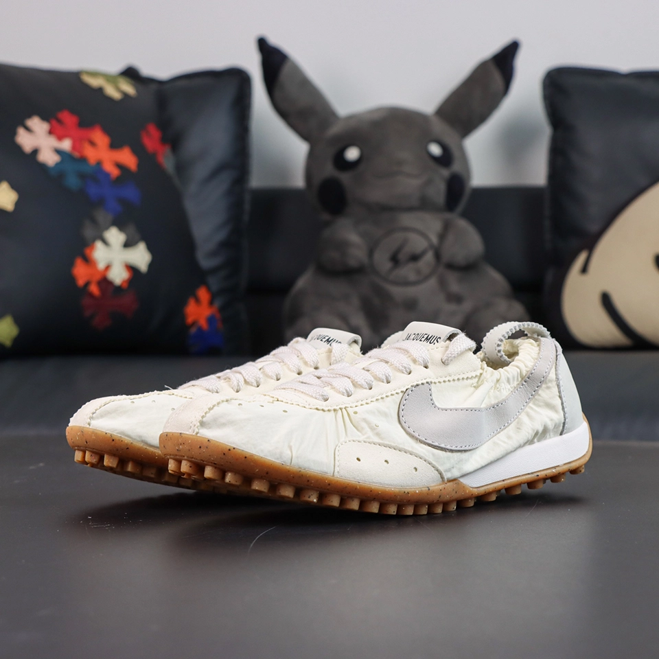 Jacquemus x Nike Moon Shoe SP “Soft Pearl” pair display showcasing a vintage low-top runner silhouette with a classic waffle outsole