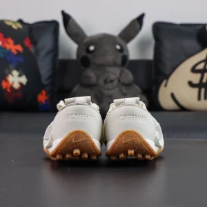 Jacquemus x Nike Moon Shoe SP “Soft Pearl” rear view highlighting embossed collaborative branding and retro heel outsole detailing