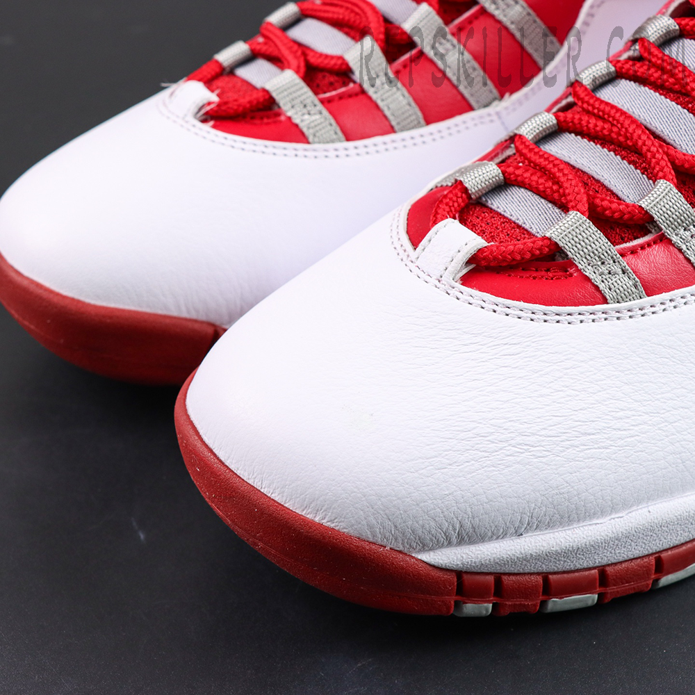 Air Jordan 10 Retro “Red Steel” toe box close-up featuring smooth white leather with red outsole and grey lace straps