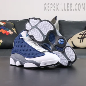 Air Jordan 13 Retro “Flint” outsole and sneaker display featuring the iconic panther paw-inspired sole in white, blue, and grey tones