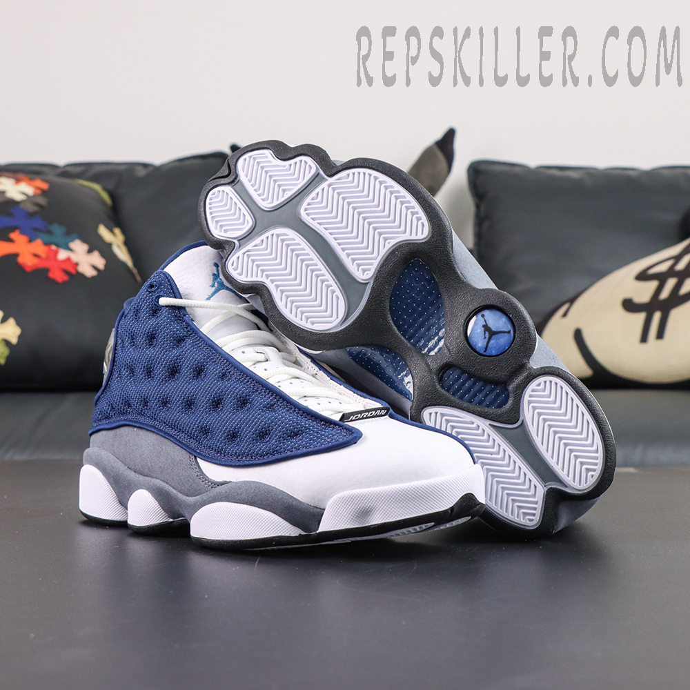 Air Jordan 13 Retro “Flint” outsole and sneaker display featuring the iconic panther paw-inspired sole in white, blue, and grey tones