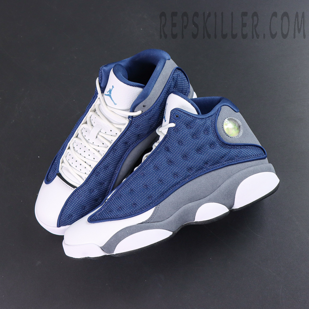 Air Jordan 13 Retro “Flint” angled top view showcasing the streamlined silhouette with navy, white, and grey color blocking