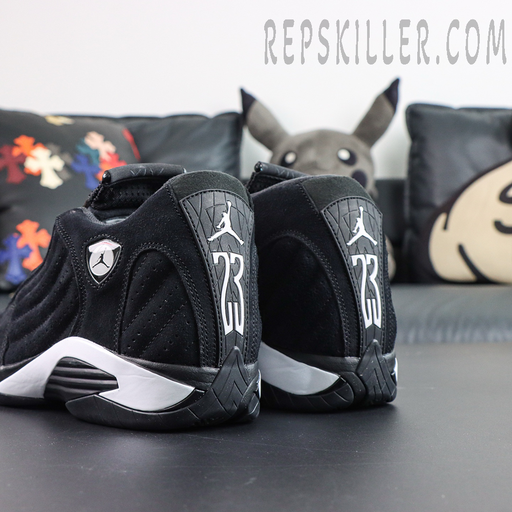 Jordan 14 Retro “Black White” rear angled view featuring the Ferrari-inspired shield logo, heel branding, and sculpted midsole details
