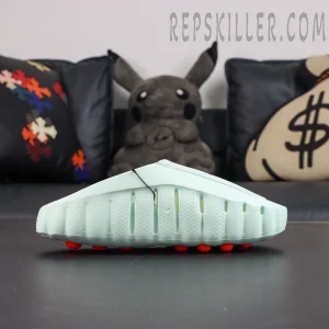Nike Mind 001 “Barely Green” lateral side view featuring a streamlined molded silhouette and orange independent cushioning nodes