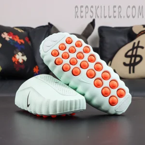Nike Mind 001 “Barely Green” outsole display featuring strategically placed orange pressure nodes for a unique underfoot experience