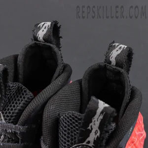 Stranger Things x Nike Air Foamposite One Premium QS “Black Bright Crimson” collar detail featuring distressed pull tabs enhancing the collaboration theme