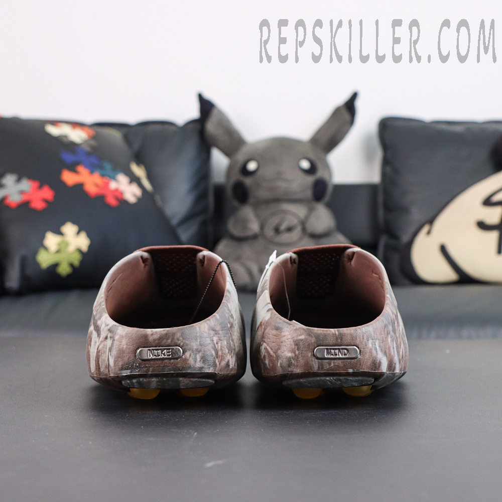Drake NOCTA x Nike Mind 001 Bronze heel detail featuring the metallic Nike badge and camouflage upper design