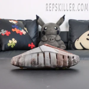 Drake NOCTA x Nike Mind 001 Bronze side view featuring perforated brown panels combined with a natural camouflage pattern