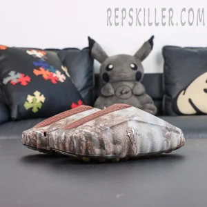Drake NOCTA x Nike Mind 001 Bronze pair showcase featuring a minimalist slip-on silhouette with camouflage detailing