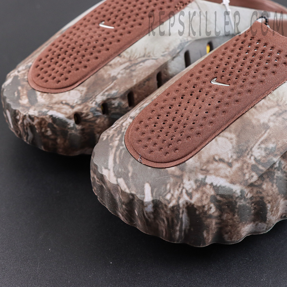 Drake NOCTA x Nike Mind 001 Bronze toe close-up featuring perforated brown panels and Nike Swoosh branding