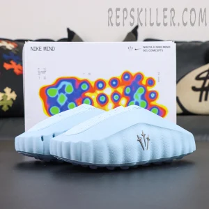 Drake NOCTA x Nike Mind 001 ‘Glacier Blue’ side profile featuring a streamlined silhouette with NOCTA metallic trident branding