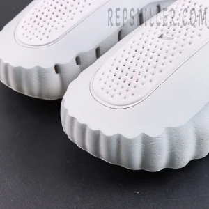 Drake NOCTA x Nike Mind 001 ‘Light Grey’ outsole detail featuring a light grey upper, breathable paneling, and orange cushioning pods for a futuristic aesthetic