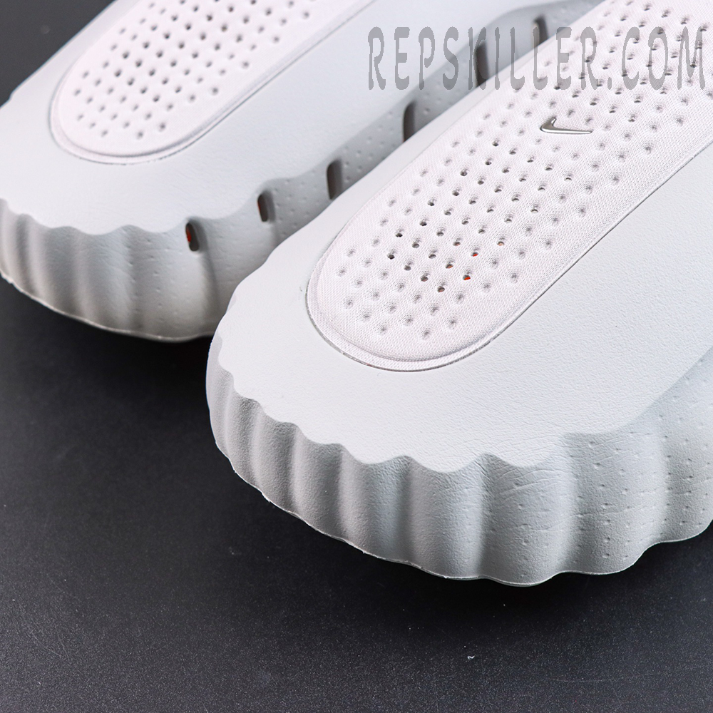 Drake NOCTA x Nike Mind 001 ‘Light Grey’ outsole detail featuring a light grey upper, breathable paneling, and orange cushioning pods for a futuristic aesthetic