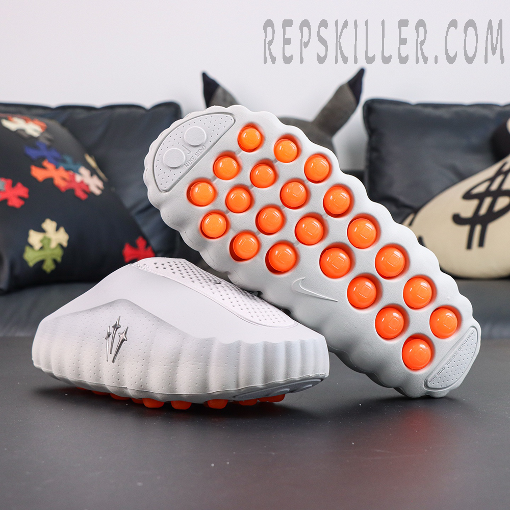 Drake NOCTA x Nike Mind 001 ‘Light Grey’ outsole view featuring a white sole with orange cushioning pods for enhanced support and bold contrast