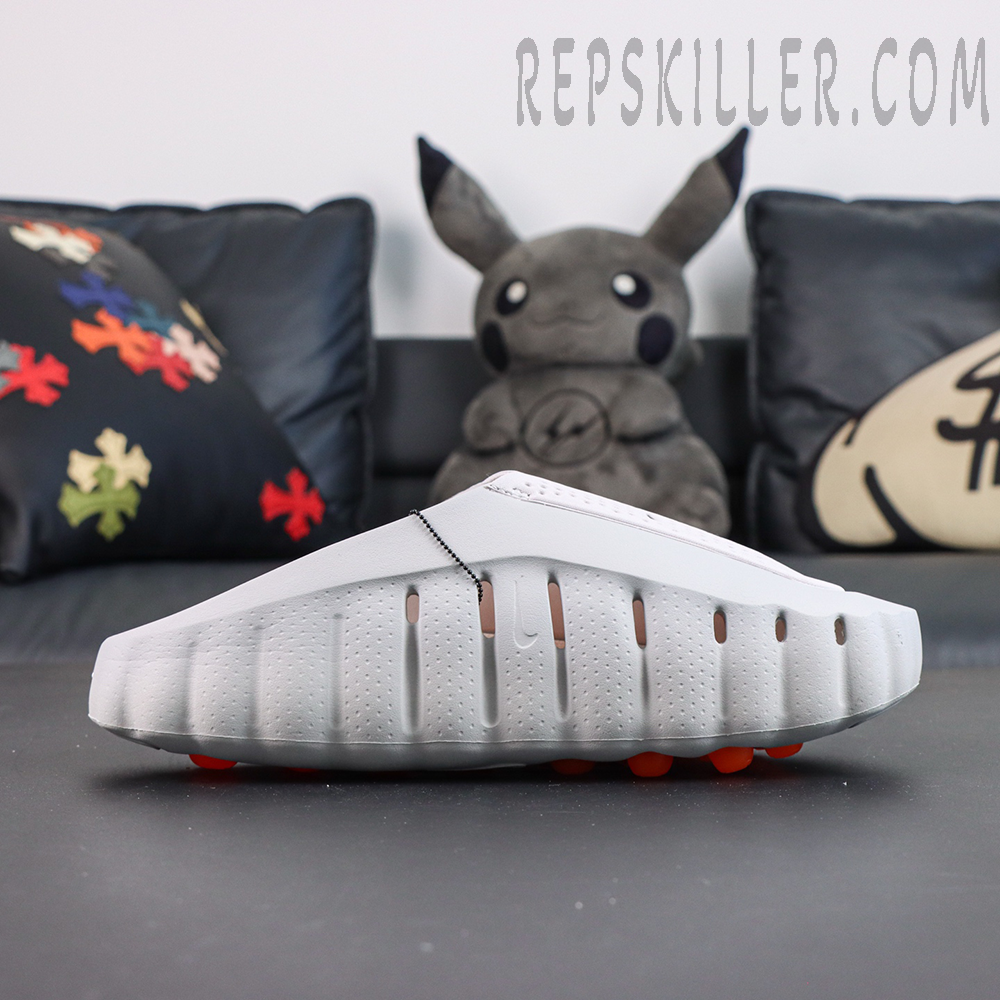 Drake NOCTA x Nike Mind 001 ‘Light Grey’ side view featuring a clean light grey upper, raised NOCTA logo, and streamlined sole construction for a futuristic lifestyle look