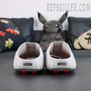 Drake NOCTA x Nike Mind 001 ‘Light Grey’ heel detail featuring metallic Nike and MIND branding with orange cushioning pods for a distinctive look